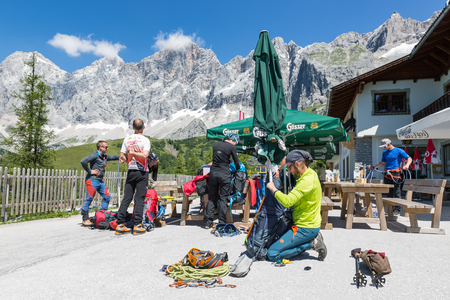 DACHSTEIN MOUNTAINS,  AUSTRIA - JULY 17, 2017: Alpinists preparing their equipment for rock-climbing in Dachstein Mountains of Austriaのeditorial素材
