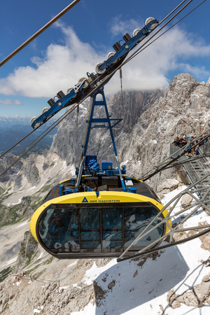 DACHSTEIN MOUNTAINS,  AUSTRIA - JULY 17, 2017: Cable car with tourists approaching the Dachstein glacier mountain station in Austriaのeditorial素材