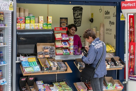 WINDSOR, ENGLAND - JUNE 09, 2017: Woman buying sweets in kiosk of Railway station near Windsor Castle.のeditorial素材