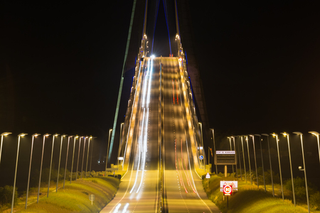Illuminated Pont de Normandy by night. Bridge over river Seine in Franceの写真素材