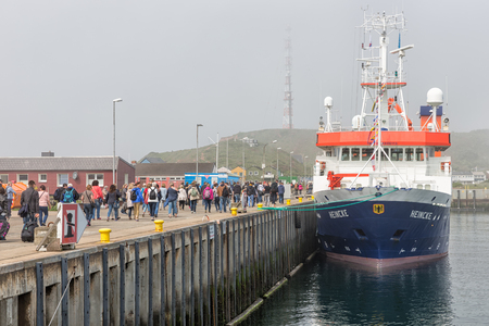 HELGOLAND, GERMANY - MAY 19, 2017: People just disembarked the ferry from Cuxhaven and walking to the village at island Helgolandのeditorial素材