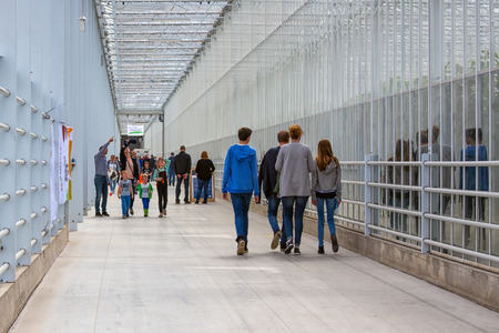 Marknesse, The Netherlands - April 07: Visitors walking in long corridor of Dutch greenhouse during a public show of the companyのeditorial素材