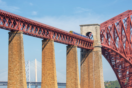 Queensferry, Scotland - May 19, 2018: Forth Bridge, railway bridge over Firth of Forth near Queensferry in Scotland with train passing the bridgeのeditorial素材