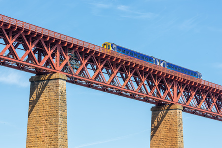 Forth Bridge, railway bridge over Firth of Forth near Queensferry in Scotland with train passing the...