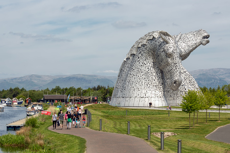 Falkirk, Scotland - May 19, 2018: People walking around the Kelpies, famous sculptures of horse heads, public art by Andy Scott in Helix park near Forth and Clyde canal Falkirkのeditorial素材