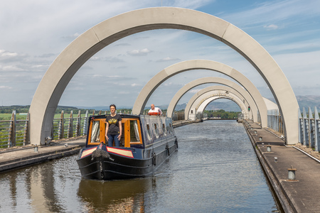 Falkirk, Scotland - May 19, 2018: Ship leaves the Falkirk Wheel, rotating boat lift in Scotland which connects the Forth and Clyde Canal with the Union Canal.のeditorial素材