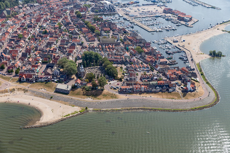 Aerial view Dutch fishing village with harbor, lighthouse and residential areaの写真素材