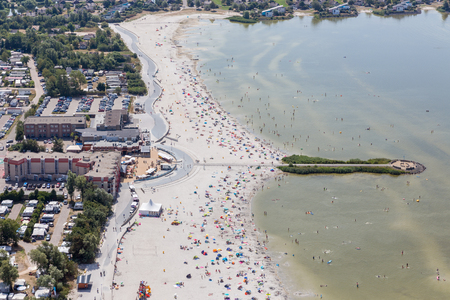 Aerial view Dutch village Makkum in Friesland with beach and swimming peopleの写真素材