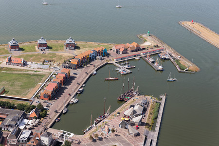 Aerial view harbor Dutch village Stavoren with traditional sailing ships and restaurantの写真素材