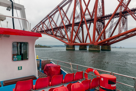 Queensferry, Scotland - May 23, 2018: Launch boat making a round trip near Forth Railroad Bridgeのeditorial素材