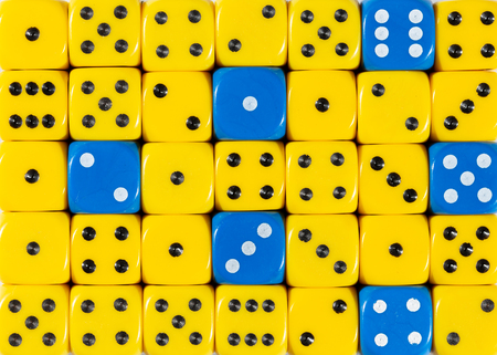 Pattern background of random ordered yellow dices with six blue cubesの写真素材