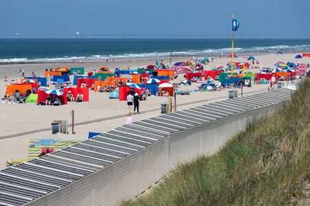 Domburg, The Netherlands - June 28, 2019: Dutch coast with seaside visitors relaxing at the beach...