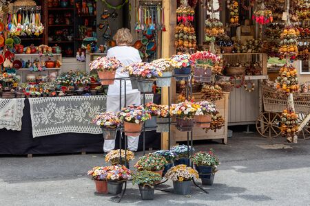 Budapest, Hungary - July 10, 2019: Souvenir shop with flowers and shopping woman near castle at Gellert Hill in Budapestのeditorial素材