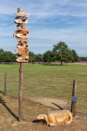 Ermelo, The Netherlands - August 23, 2019: Wooden sheep and pole with arrow signs to several interesting locations near Ermelo sheepfoldのeditorial素材