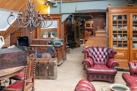Weerselo, The Netherlands - August 16, 2019: Exposition of vintage furniture with Chesterfield armchair at Dutch flea marketのeditorial素材