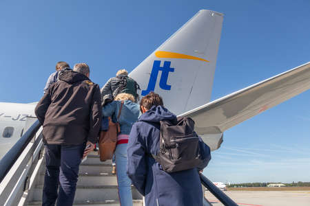 Eindhoven, The Netherlands - May 13, 2019: Travelers entering an airplane ready for departure at Eindhoven airportのeditorial素材