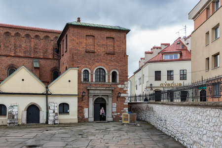 Krakow, Poland - May 16, 2019: Woman leaving Stara Synagogue in Jewish Quarter Krakowのeditorial素材