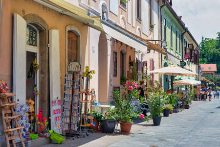 Eger, Hungary - July 05, 2019: Souvenir shops and shopping people downtown medieval city Eger, Hungaryのeditorial素材