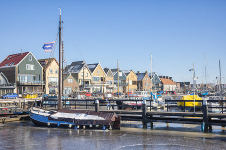 Urk, The Netherlands - Februari 13, 2021: Frozen harbor of urk with jetty and old wooden fishing shipsのeditorial素材