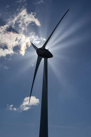 Black silhouet windturbine with backlight and sunraysの写真素材