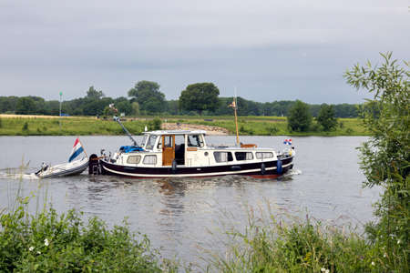 Cruiser sailing near Arcen at Dutch river Meuseのeditorial素材