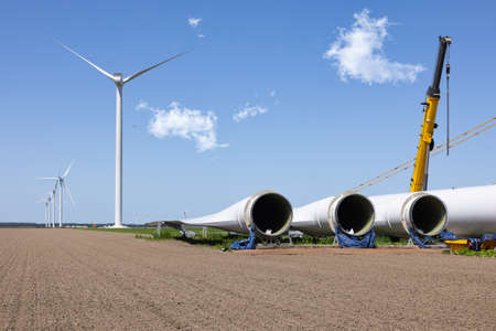 Dutch construction site windturbine farm with wings ready to install