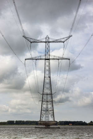 Electricity pylon in Dutch Ketelmeer between Noordoostpolder and Flevolandの写真素材