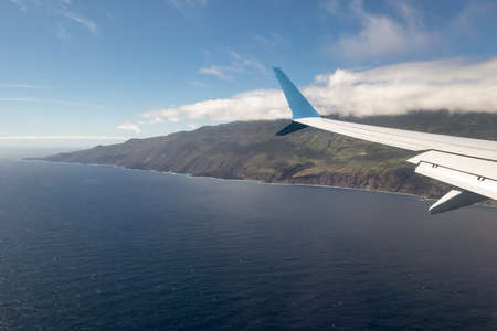 Wing airplane above Atlantic Ocean approaching Canary Island La Palma