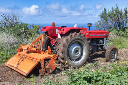Tractor in green fields with Ocean view, la Palma island