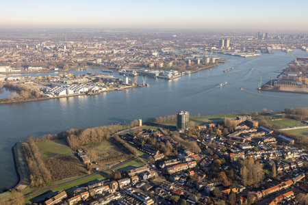 Dutch river Nieuwe Maas near Rotterdam with harbors and houses
