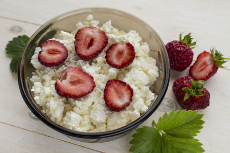 cottage cheese with ripe berries, wild strawberries and mint leavesの写真素材