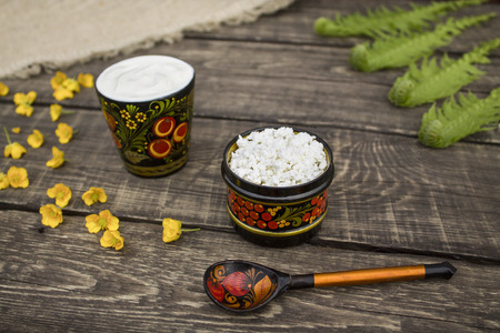 The cheese and sour cream in a bowl with Khokhloma painting