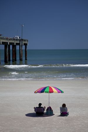 Couple with beach umbrella at beachの写真素材