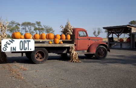 Pumpkins on old red farm truck with sign の写真素材