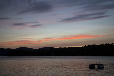 Sunset and colorful clouds over Squam Lake, New Hampshireの写真素材