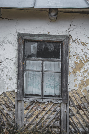 Old window in a ruined house in the village.の写真素材