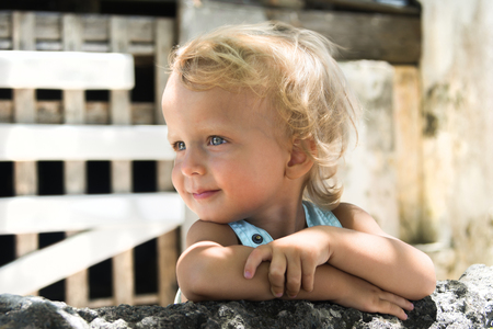 Cute little boy with blonde curly hair. Vacation with kids.の写真素材