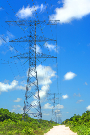 Electric high voltage tower on blue sky background.の写真素材
