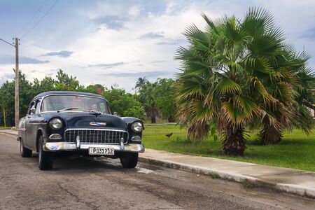 Varadero/Cuba-june 2017.Retro black american car near palms in Cubaのeditorial素材
