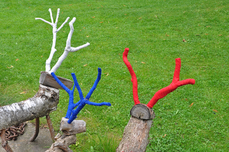Wooden statues of deer with colored antlers.の写真素材