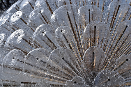 Detail of a water fountain in the afternoon spring sunshine.の写真素材