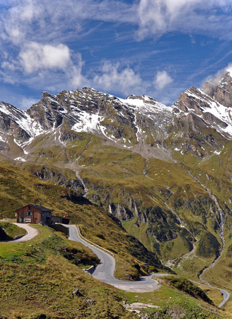 Waterfall and asphalt road in Hohe Tauern. Austria.の写真素材