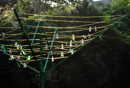 Dew drops in the morning on the clamps and ropes of the green stand.の写真素材