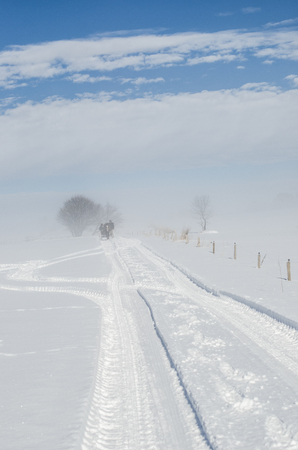 invisible snowy path and blue skyの写真素材