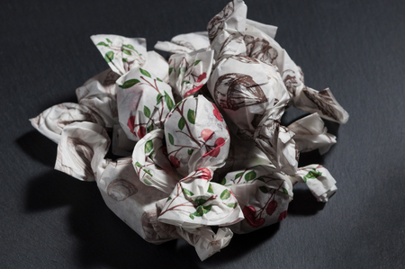 a mountain of handmade candies lie on a black backgroundの写真素材