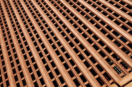 orange metal grill photographed at an angle for texture, background, text or imageの写真素材