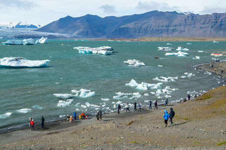Vatnajokull, Iceland - 11th of August 2009: Tourists are enjoying the view, icebergs in Blue Lagoon. High quality photoのeditorial素材