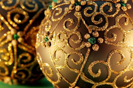 Christmas balls with gold ornament on the green backgroundの写真素材