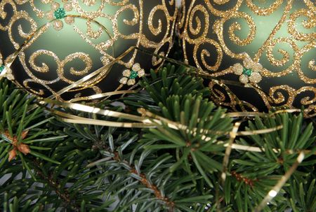 Christmas balls with gold ornament on the green pine branchesの写真素材