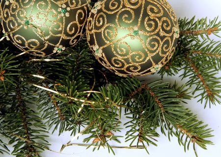 Christmas balls with gold ornament on the green pine branchesの写真素材